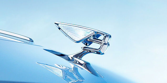 Giltrap Christchurch Bentley Flying Spur Azure sedan bonnet close up in Light Windsor Blue paint with Illuminated Flying B mascot